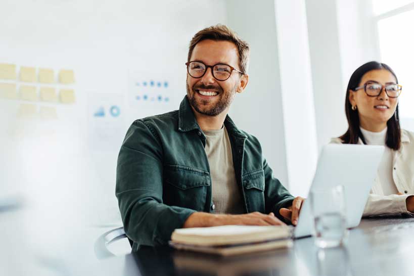 man_with_glasses_smiling_meeting-1